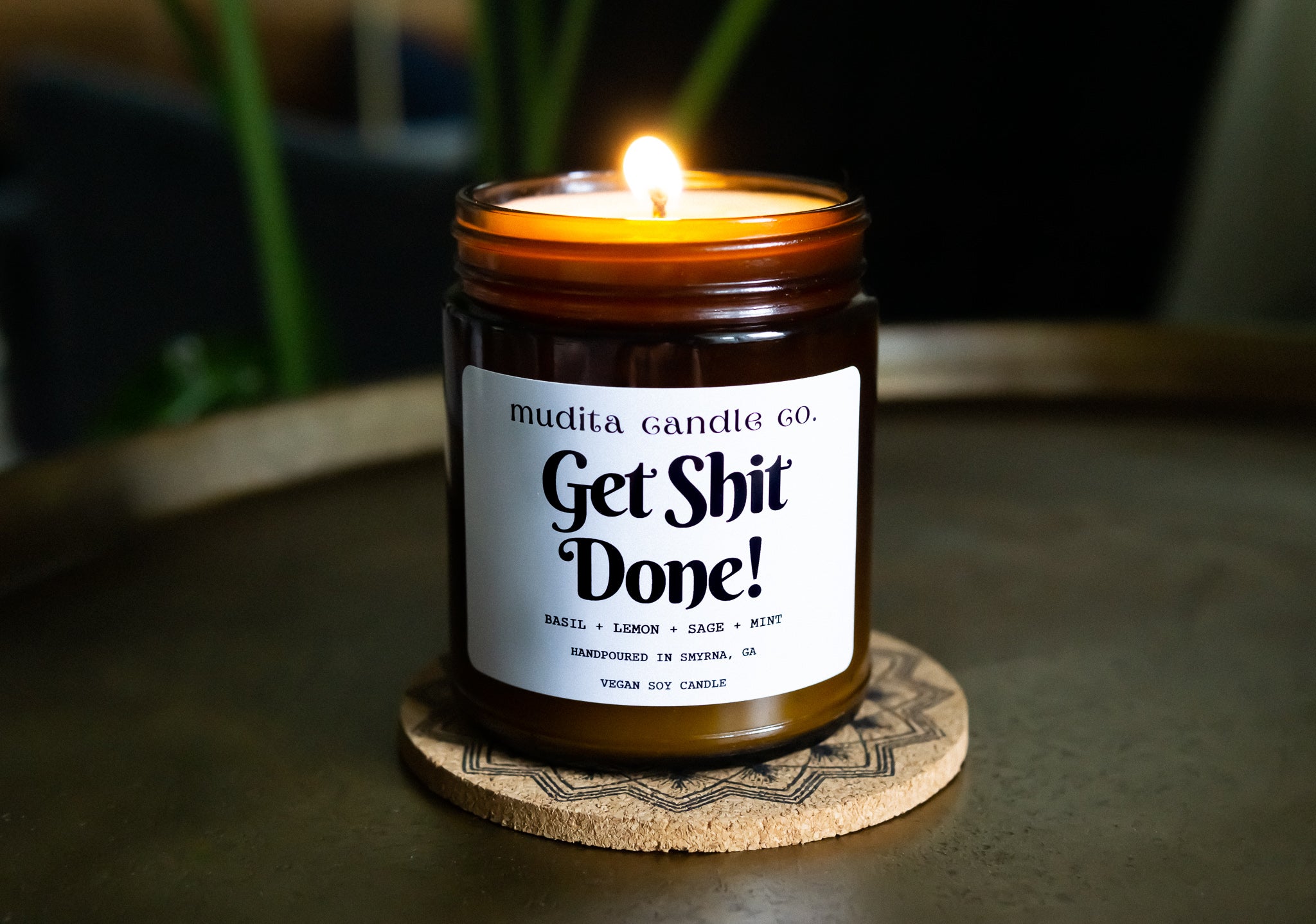 Get Shit Done! Soy Candle in amber glass jar with gold lid, featuring basil, sage, mint, and lemon scents.